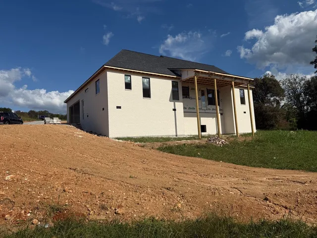 a view of a house with a backyard
