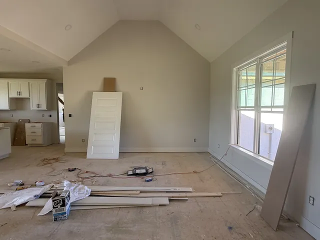 a view of a room with workspace and a window