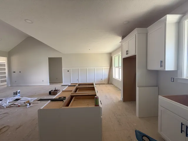 a view of kitchen with a sink a window and stainless steel appliances