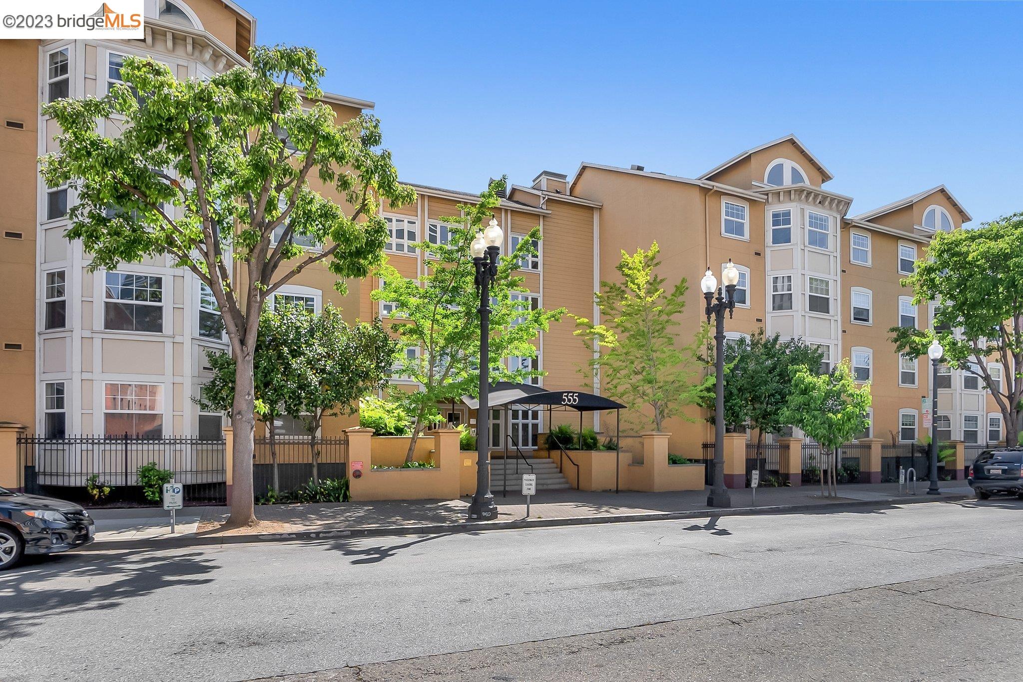 a front view of a building with tree s