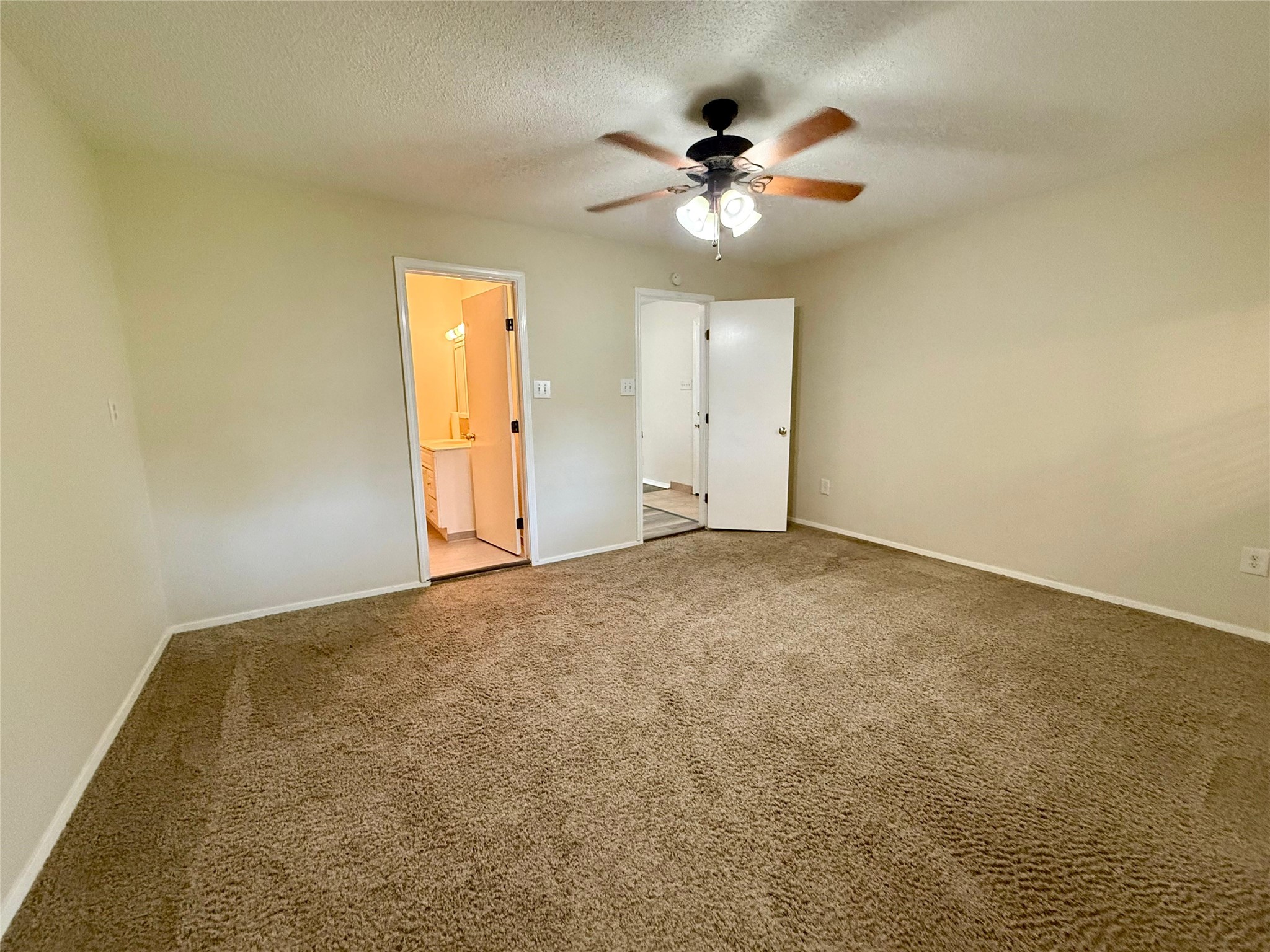 17903 Strack Drive East, Unit GARAGE Spring, TX 77379 - Photo 14 of 22 Spacious bedroom with adjacent bathroom.
