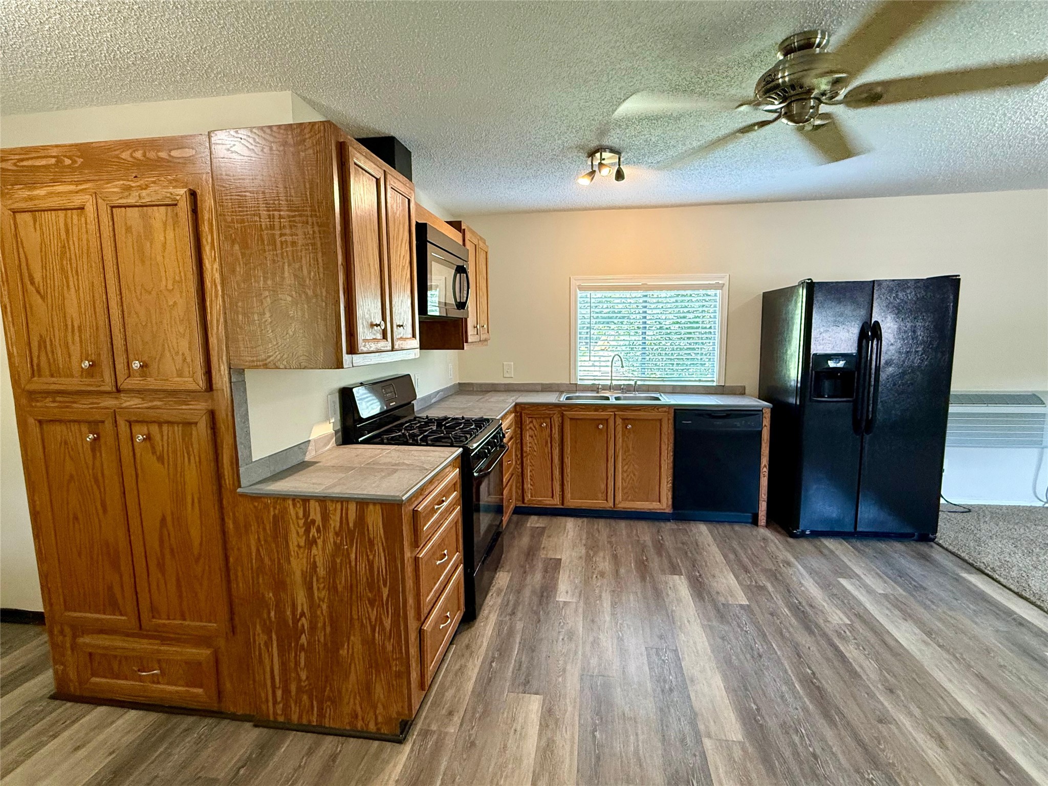 17903 Strack Drive East, Unit GARAGE Spring, TX 77379 - Photo 8 of 22 Kitchen with full size refrigerator, dishwasher, microwave and stove with oven.