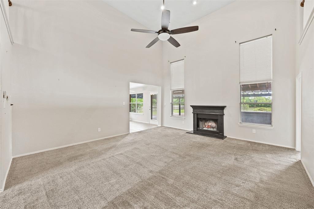 3931 Alpha Way Midlothian, TX 76065 - Photo 10 of 33 a view of an empty room with a fireplace and a window