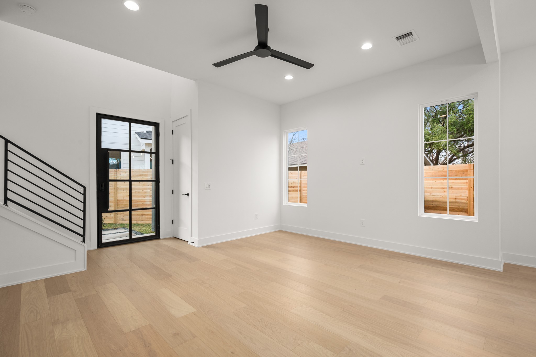 601 Vermont Road, Unit 2 Austin, TX 78702 - Photo 11 of 23 Light wood-finish flooring with white baseboards throughout the room