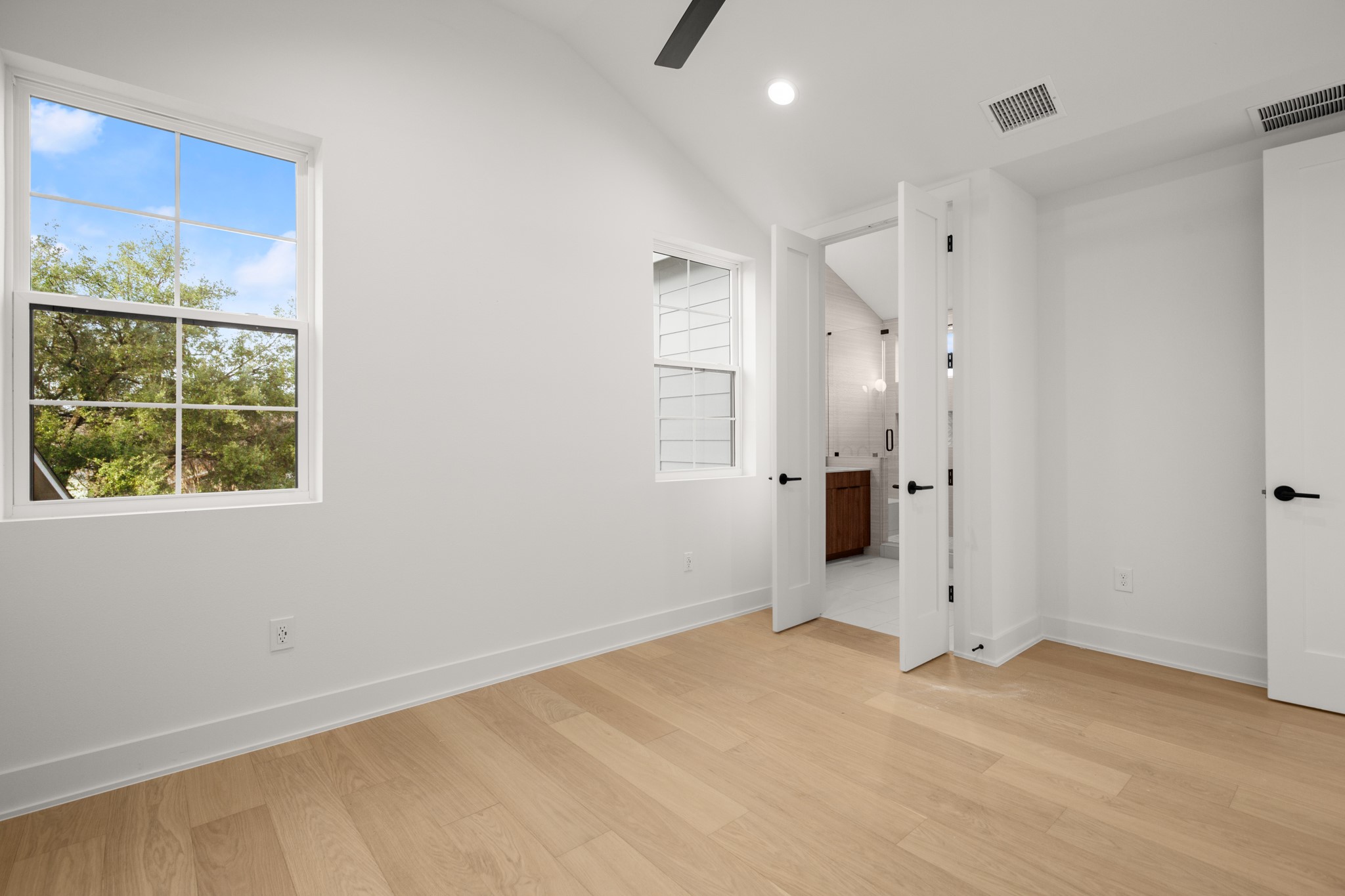 601 Vermont Road, Unit 2 Austin, TX 78702 - Photo 17 of 23 Vaulted ceiling with an exposed beam, light wood-finish flooring, and white baseboards