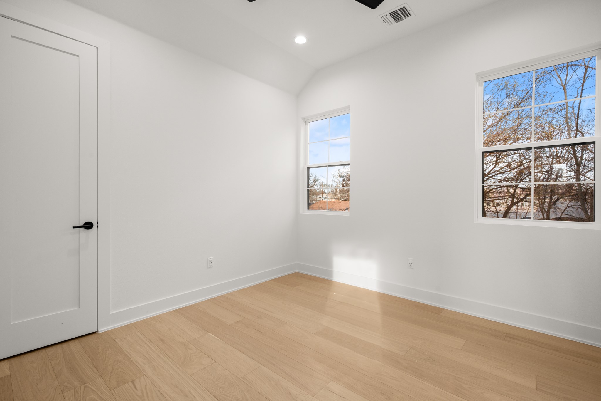 601 Vermont Road, Unit 2 Austin, TX 78702 - Photo 20 of 23 Bright room featuring light wood-finish flooring and white walls