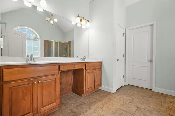 a bathroom with a double vanity sink and a mirror
