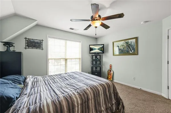 a bedroom with a large bed and a window