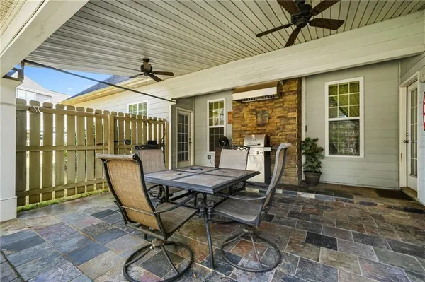 a view of a patio with table and chairs