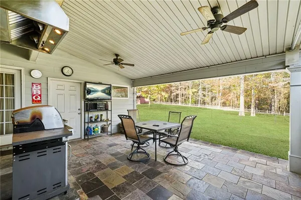 a view of a porch with furniture and a yard