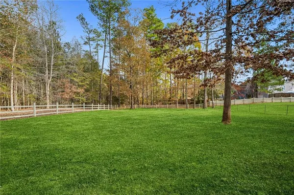 an aerial view of a house with yard