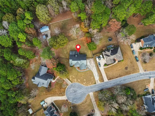 an aerial view of a house with a yard