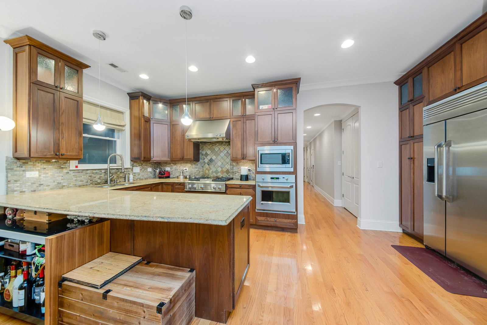 1238 West Jackson Boulevard, Unit 2W Chicago, IL 60607 - Photo 4 of 13 a large kitchen with stainless steel appliances kitchen island granite countertop a sink and cabinets