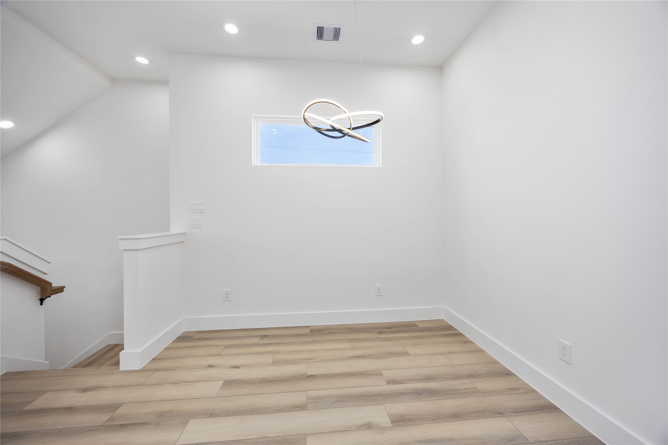 6735 Peerless Street, Unit C Houston, TX 77021 - Photo 8 of 27 a view of a room with wooden floor and white walls