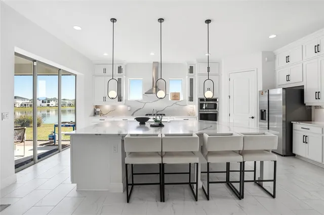 a kitchen with stainless steel appliances a stove a sink and cabinets