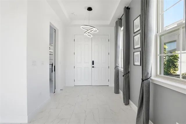a living room with furniture potted plant and a large window