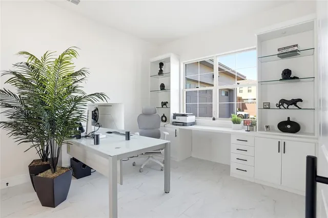 a living room with furniture a chandelier and a flat screen tv