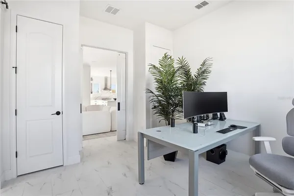 a living room with furniture large windows and a flat screen tv