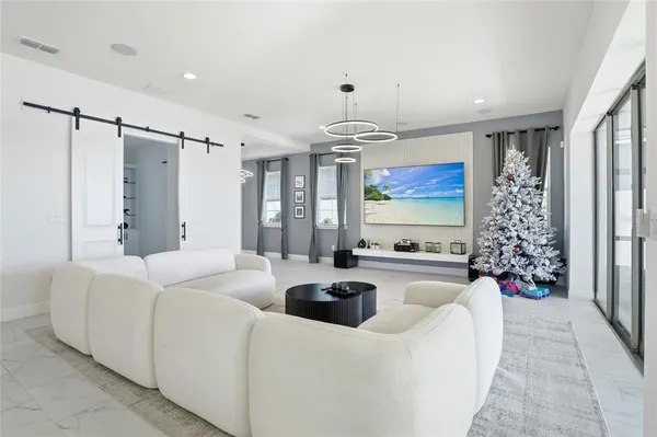 a kitchen with stainless steel appliances kitchen island granite countertop a table chairs sink and cabinets