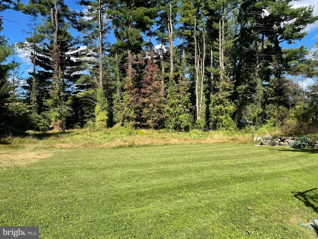 a view of outdoor space with deck and yard