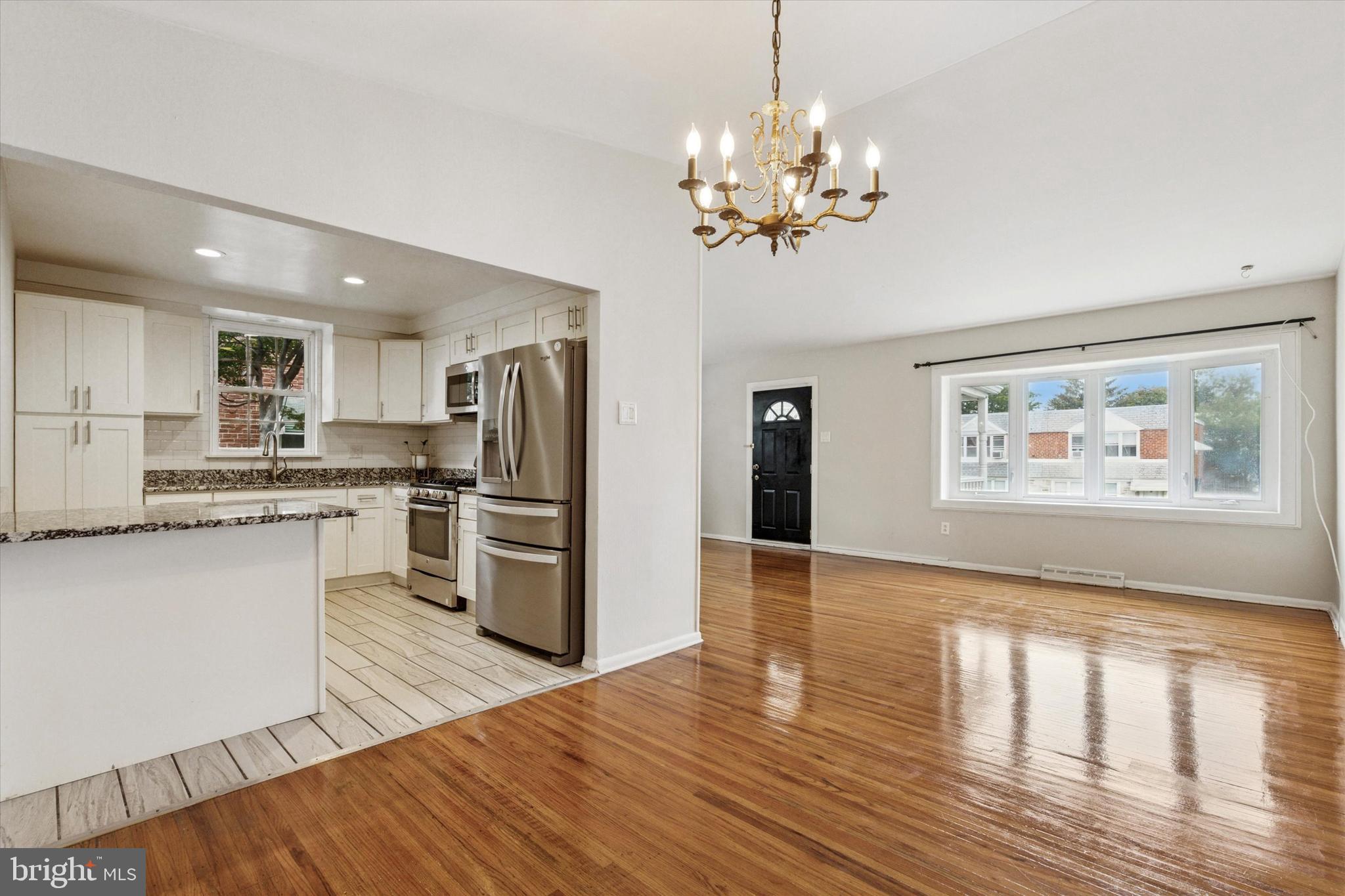2678 Tremont Street Philadelphia, PA 19152 - Photo 1 of 24 a open kitchen with stainless steel appliances granite countertop a refrigerator a stove oven a sink dishwasher with a dining table and chairs