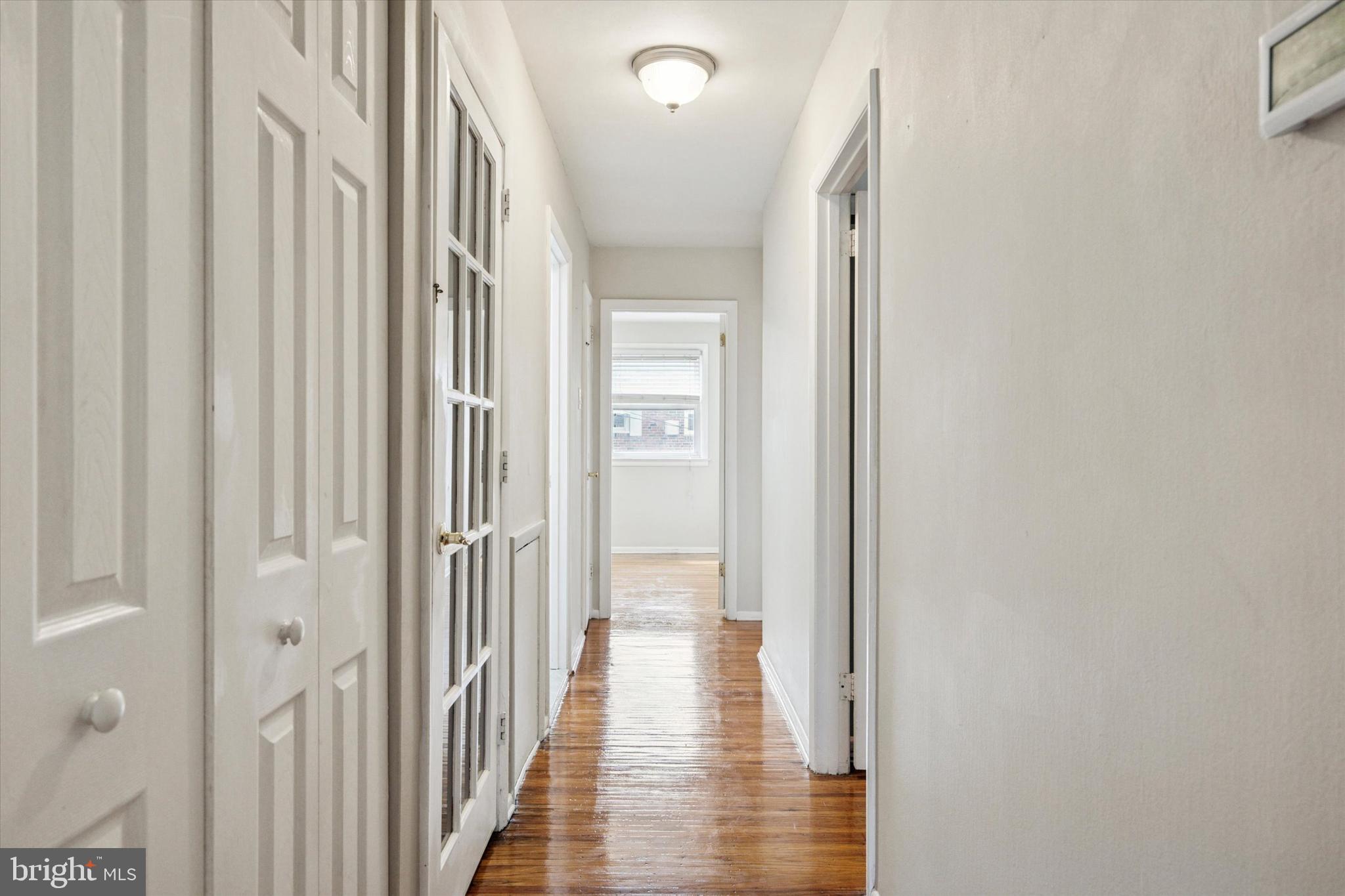 2678 Tremont Street Philadelphia, PA 19152 - Photo 13 of 24 a view of a hallway with wooden floor and a bathroom