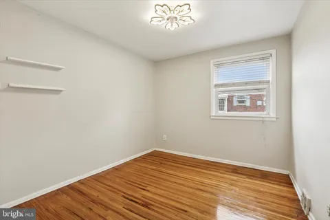 a view of a room with wooden floor and windows