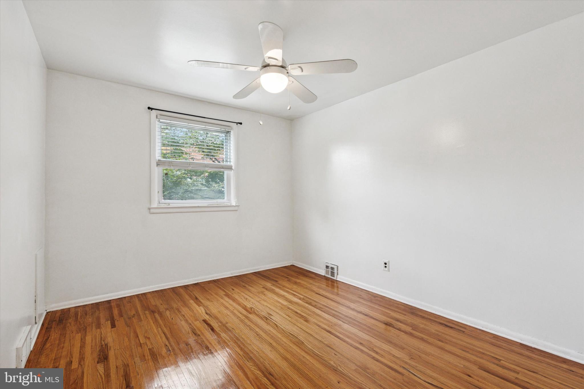 2678 Tremont Street Philadelphia, PA 19152 - Photo 18 of 24 wooden floor in an empty room with a window