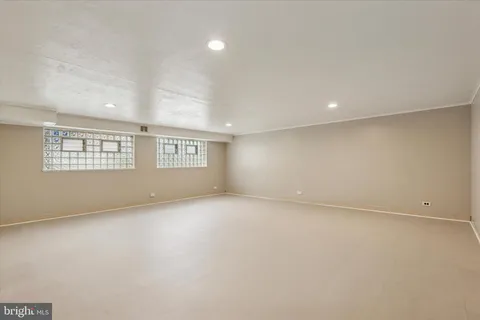 an empty room with a empty space and windows