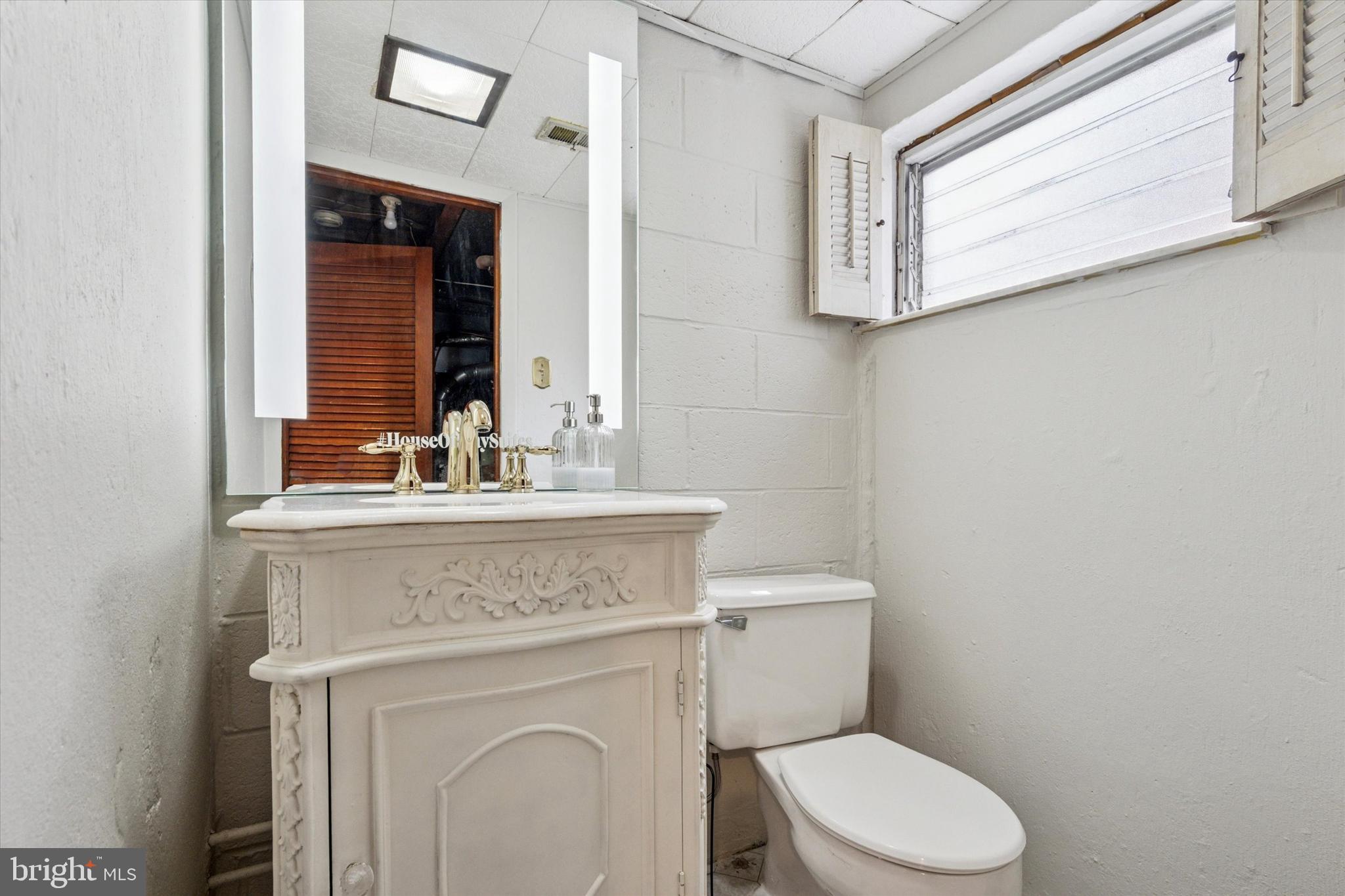 2678 Tremont Street Philadelphia, PA 19152 - Photo 24 of 24 a bathroom with a granite countertop toilet sink and mirror