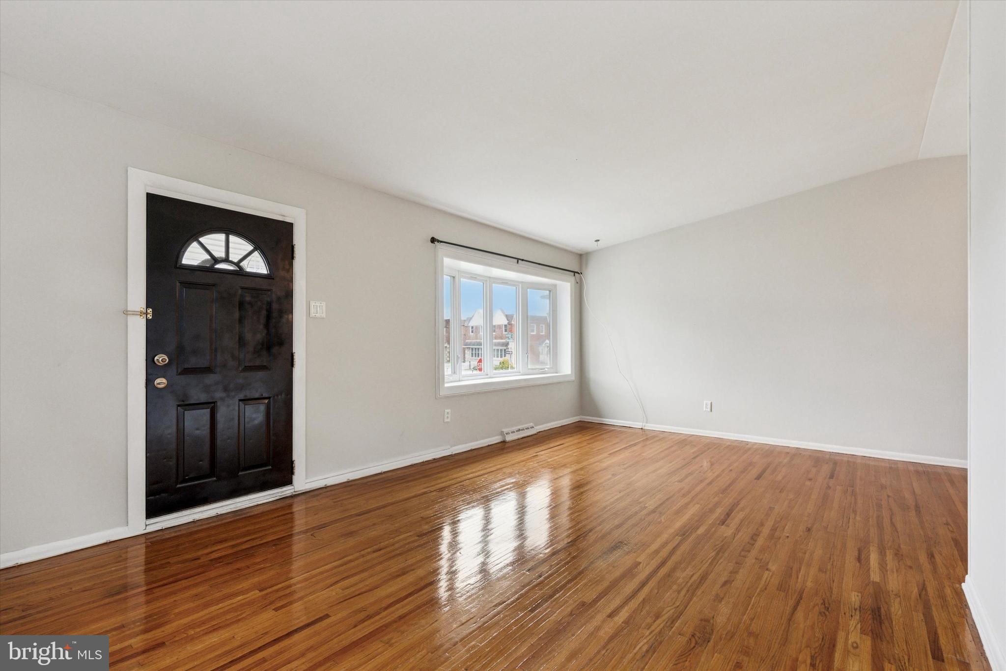 2678 Tremont Street Philadelphia, PA 19152 - Photo 5 of 24 a view of an empty room with window and wooden floor