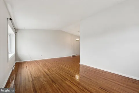 an empty room with wooden floor