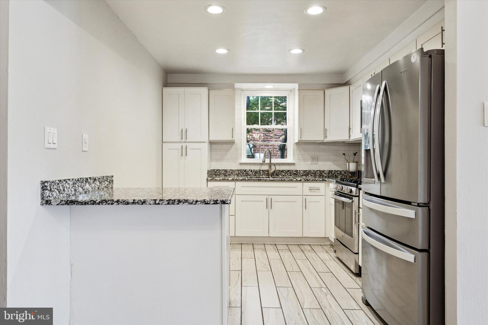2678 Tremont Street Philadelphia, PA 19152 - Photo 10 of 24 a kitchen with a refrigerator and white cabinets