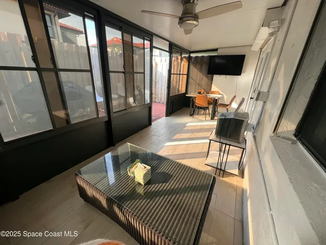 a living room with furniture and a floor to ceiling window