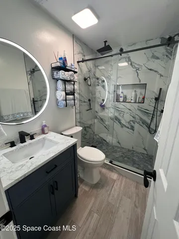 a bathroom with a sink mirror vanity and toilet