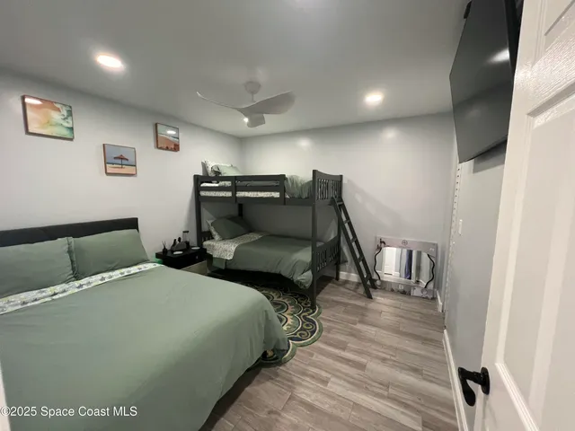 a bed room with two bed and a wooden floor