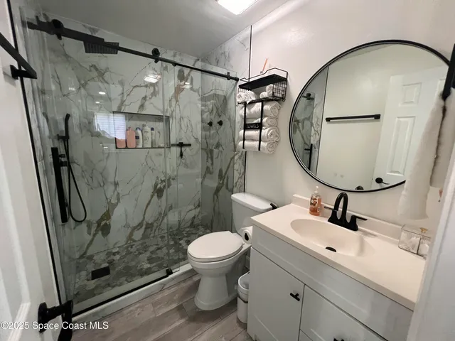 a bathroom with a sink toilet and shower