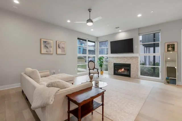a living room with furniture a fireplace and a flat screen tv