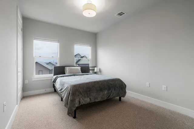 a bathroom with a granite countertop bathtub sink vanity mirror and toilet