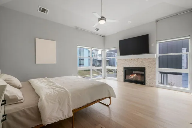 a bedroom with a large bed and a fireplace