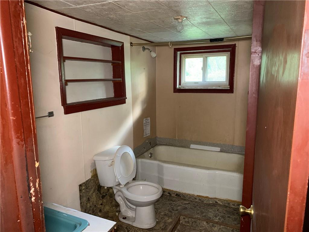 302 Arcadia Road Arcadia, PA 15712 - Photo 13 of 25 a bathroom with a toilet a sink and a bathtub