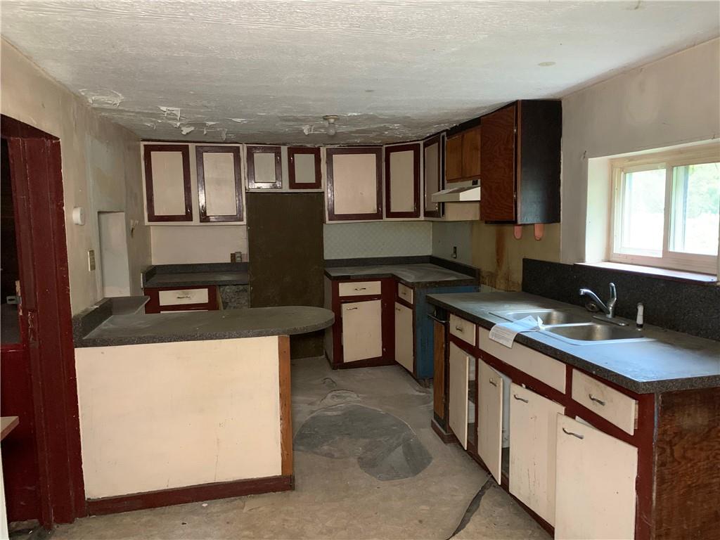 302 Arcadia Road Arcadia, PA 15712 - Photo 2 of 25 a kitchen with kitchen island granite countertop a sink stove and refrigerator
