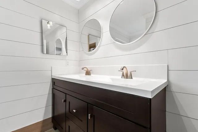 a bathroom with a sink vanity and a mirror