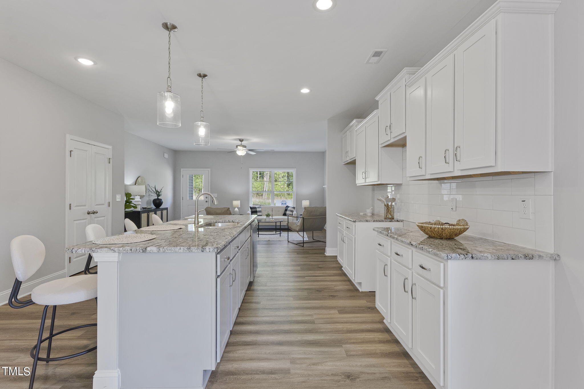 93 Regis Lane Coats, NC 27521 - Photo 13 of 31 a large kitchen with stainless steel appliances kitchen island granite countertop a sink and cabinets