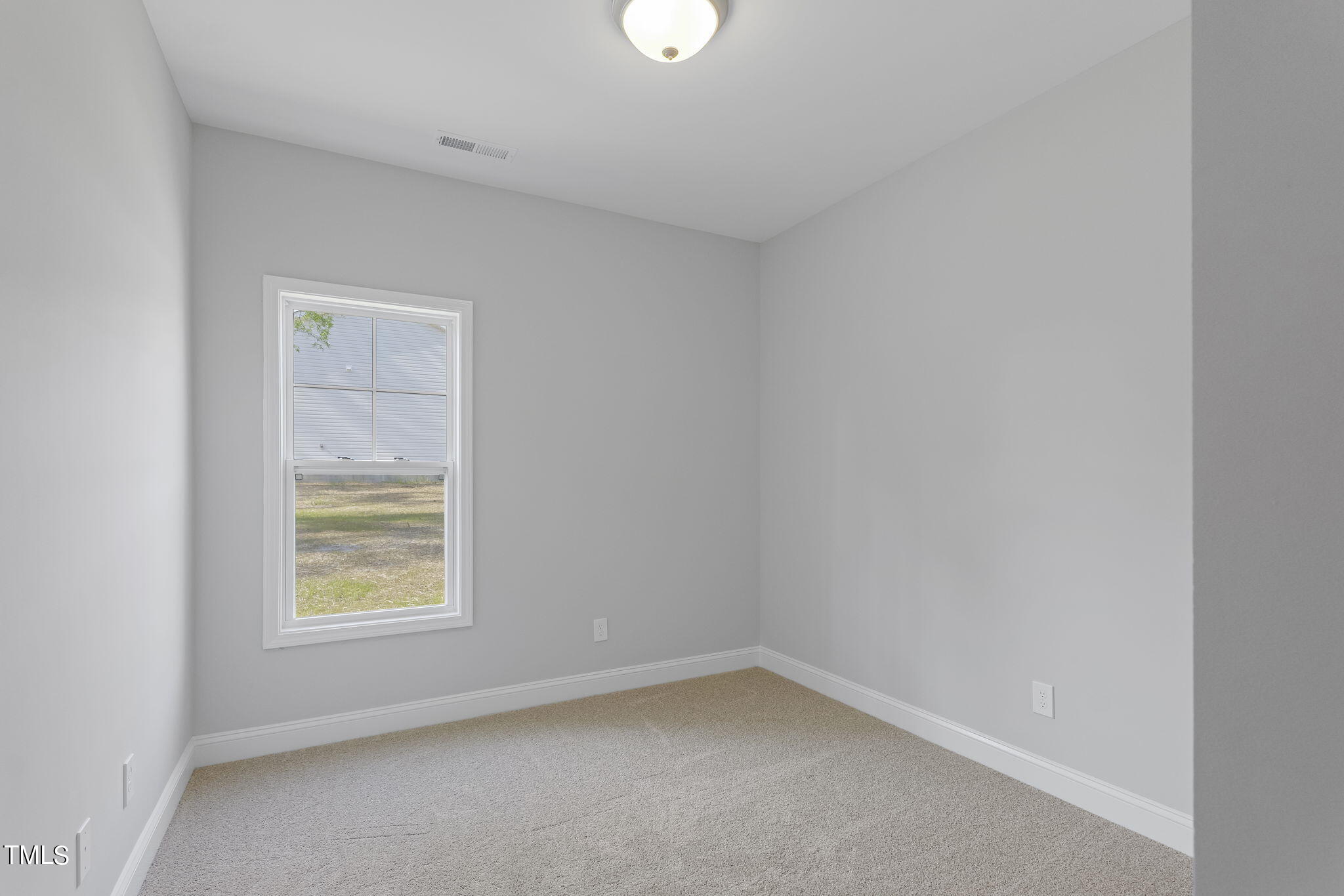 93 Regis Lane Coats, NC 27521 - Photo 21 of 31 a view of an empty room with a window