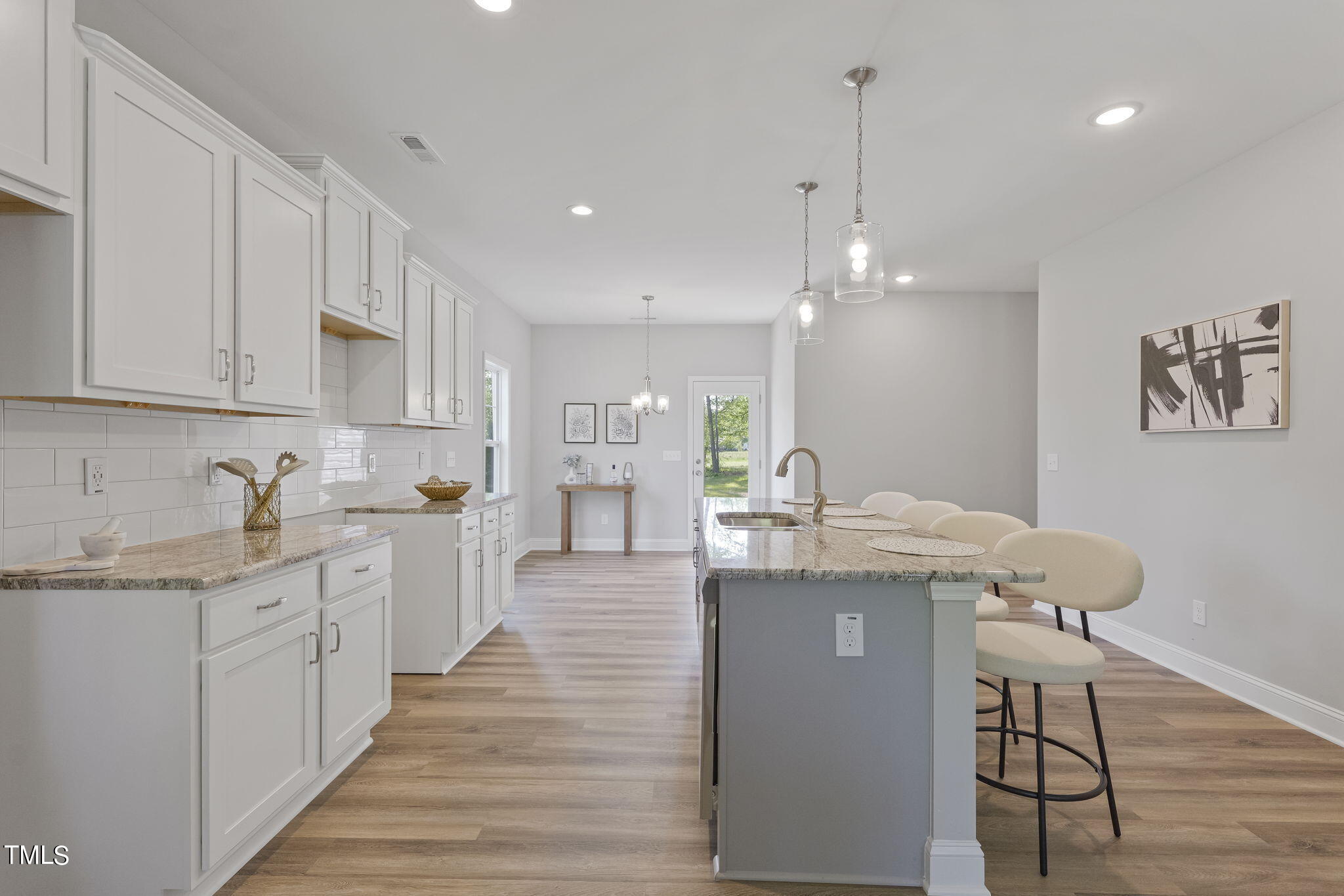 93 Regis Lane Coats, NC 27521 - Photo 10 of 31 a open kitchen with kitchen island a sink stove and wooden floor