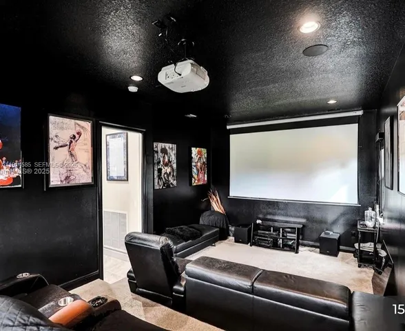 a room with furniture projector and screen