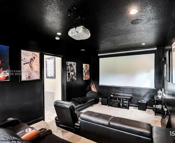 a room with furniture projector and screen