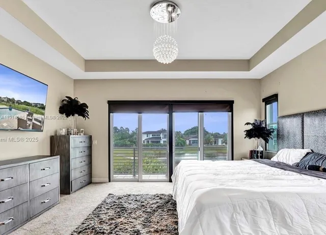 a bedroom with a large bed and a large window