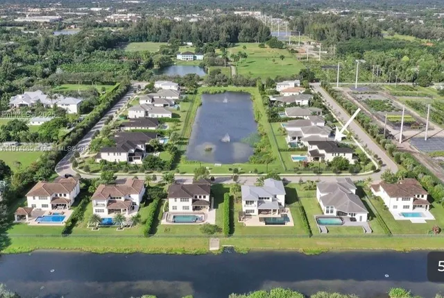 an aerial view of multiple houses with yard